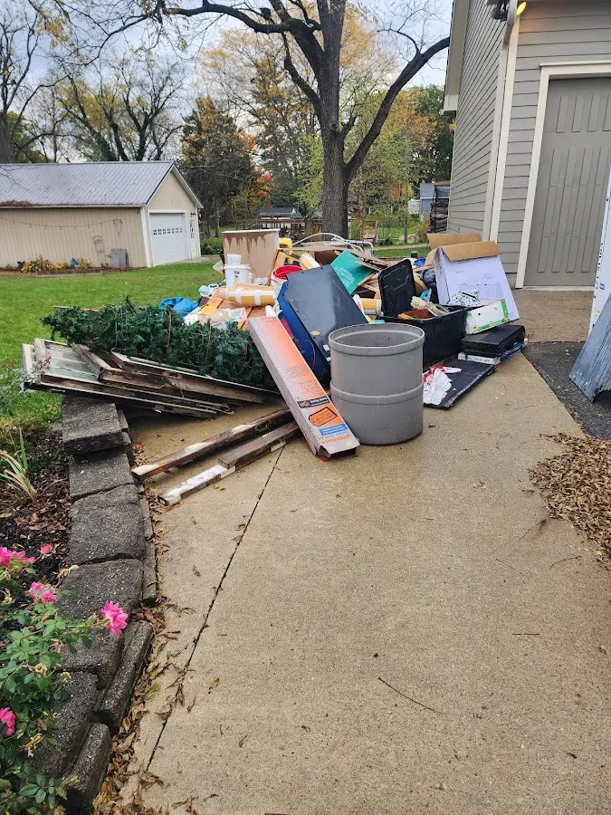Dumpster being loaded with debris for Roofing Dumpster Rental in Whetstone